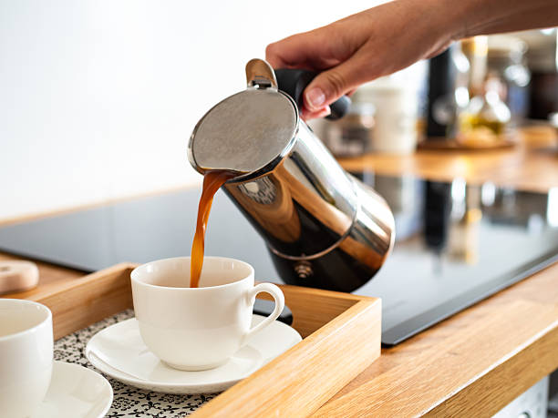 istock Pouring coffee from coffee pot into cups, close-up 2223636263