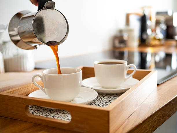 istock Pouring coffee from coffee pot into cups, close-up 2223636270
