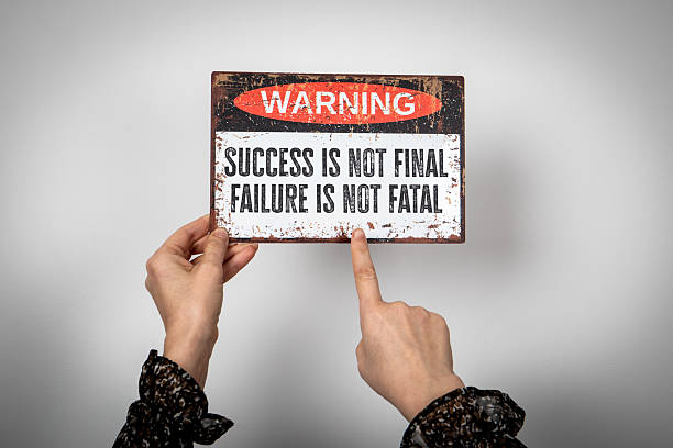 istock Motivational Warning Sign Held by Hands with Quote About Success and Failure 2223636336