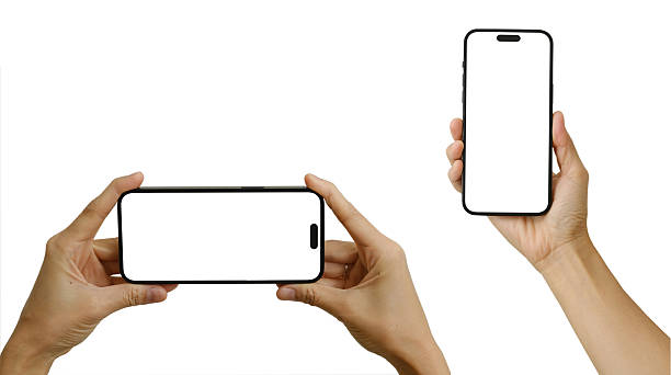 istock Hand holding the black smart phone with blank screen and modern frameless design in two rotated perspective positions - isolated on white background - Clipping Path 2223637141