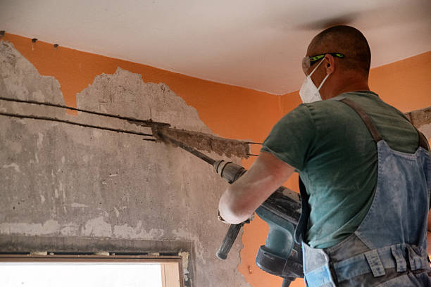 istock worker with jackhammer working on reconstruction of old apartment. word work written on the wall 2223637287