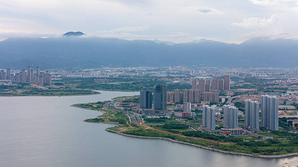 istock China Xiamen Urban Lakeside Scenery with Mountain Ranges 2223639364