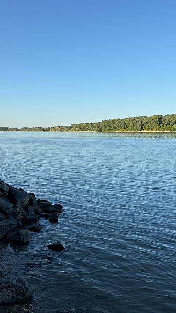 istock Rocky lake shore under blue sky 2223640907