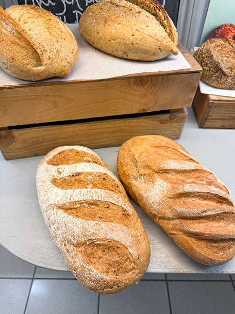 Image of artisan sourdough bread loaves / crusty homemade baked goods, rustic dough texture, freshly baked in traditional bakery style