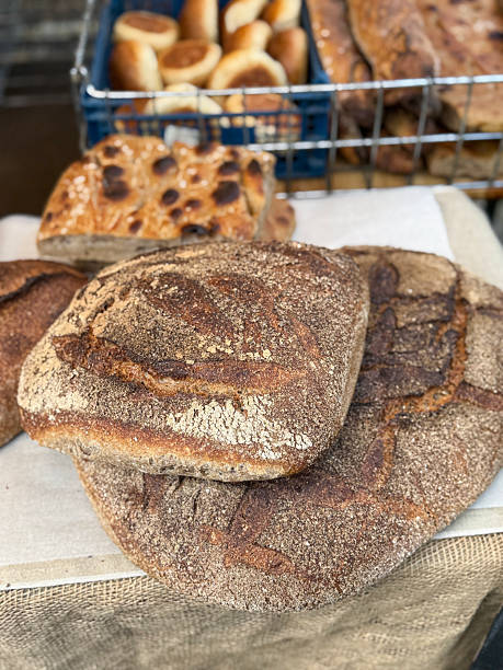 Image of artisan sourdough bread loaves / crusty homemade bakery baked goods with rustic dough, traditional handcrafted loaf