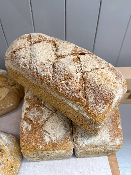 Image of artisan sourdough bread loaves / crusty homemade bakery baked goods, rustic dough texture, freshly baked handcrafted loaf