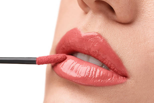 istock Woman applying lip gloss on white background, closeup 2223641640