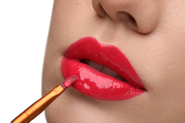 istock Woman applying lip gloss on white background, closeup 2223641657
