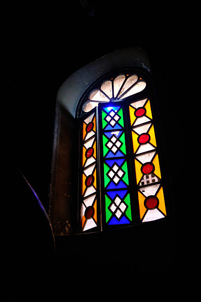 istock Colorful stained glass window in dark interior 2223645395