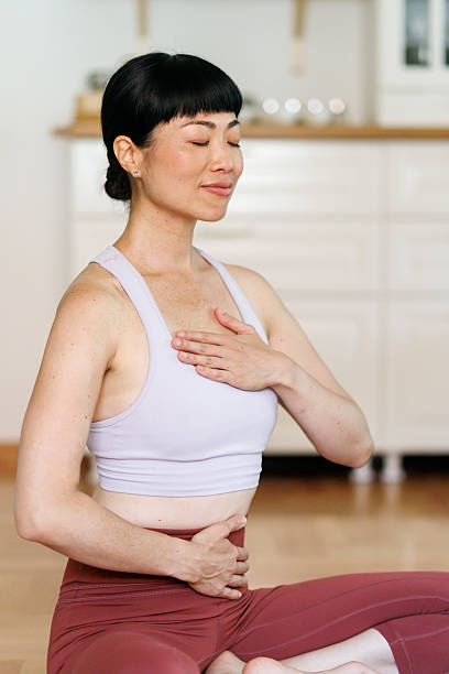 istock Woman doing breathing exercise at home 2223646051