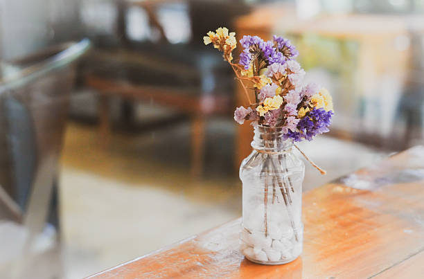 istock the flower in the bottle on the table with dramatic tone 2223648684