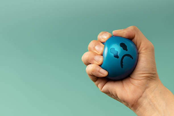 Hand Squeezing a ball used for emotional control and mental health practice, helping Stressed person reduce tension and improve mood.