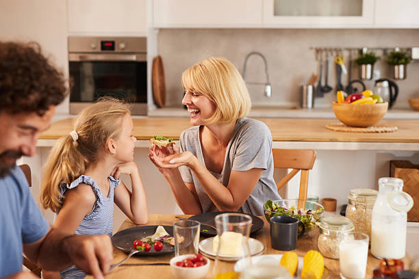 istock Happy family having breakfast together in a modern kitchen 2223654017