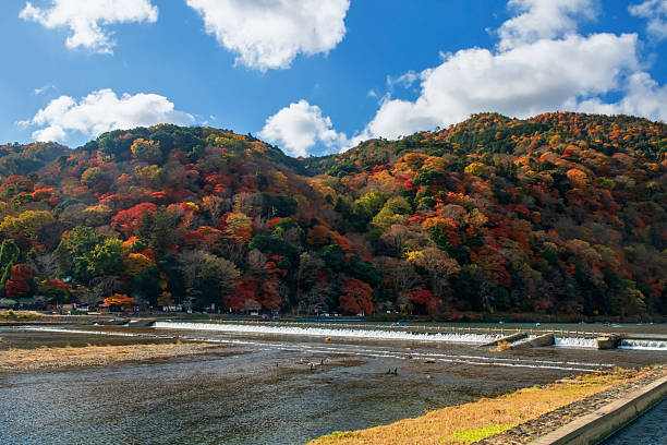 istock Katsura river by mountain with fall leaf colors and blue sky, Arashiyama 2223656002