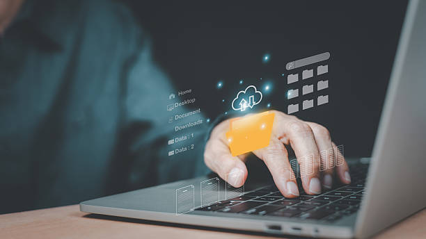 istock Businessman working on laptop with virtual screen upload backup document management, cloud computing online documentation database and document management system concept. 2223656945
