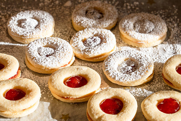 Classic German Christmas sandwich cookies with a layer of jam in the middle. Popular Christmas cookies. Traditional shortbread that are cut out and filled with marmalade and frosted with a powdered sugar glaze.
