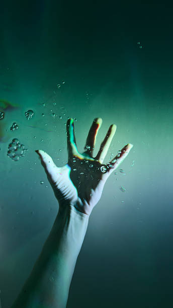 istock A Captivating Underwater Scene Featuring an Outstretched Hand Reaching Towards the Surface, Surrounded by Bubbles and Soft Light - A Symbol of Struggle and Hope Beneath the Waves 2223659416