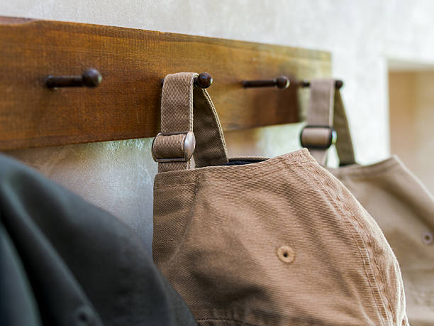 istock Casual Caps Hanging on Wooden Hooks 2223660894