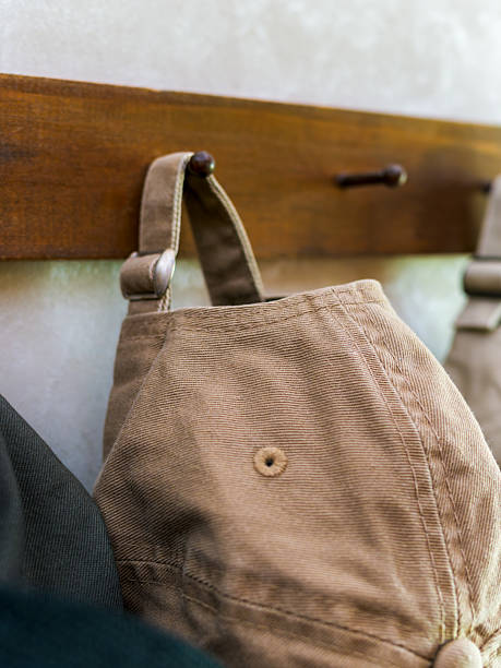 istock Casual Caps Hanging on Wooden Hooks 2223660934