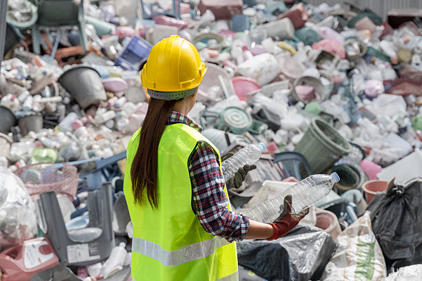 istock Female Worker Sorting Plastic Bottles at Waste Recycling Center 2223661061