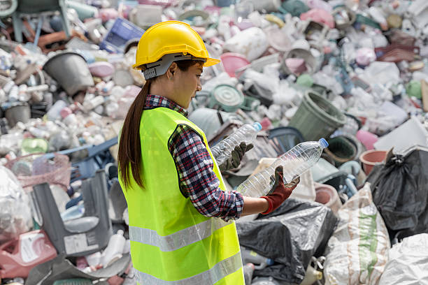 istock Female Worker Sorting Plastic Bottles at Waste Recycling Center 2223661215