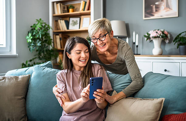 istock Mother and daughter sharing a happy moment while using a smartphone at home 2223665458