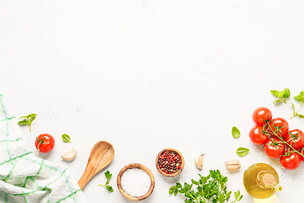 istock Spices, herbs and vegetables with olive oil on white kitchen table. 2223665535