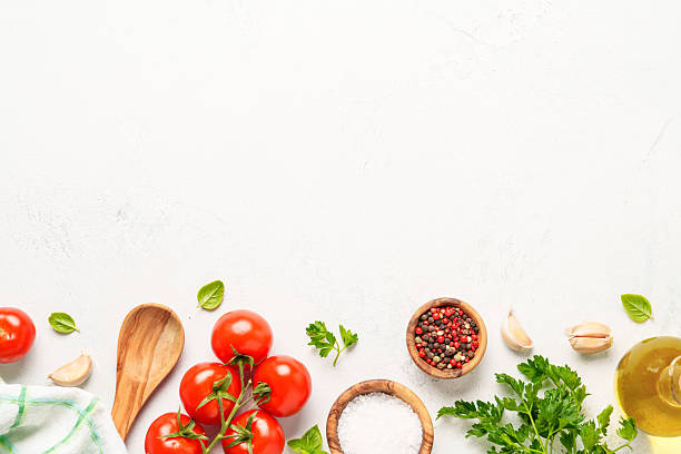 istock Spices, herbs and vegetables with olive oil on white kitchen table. 2223665539
