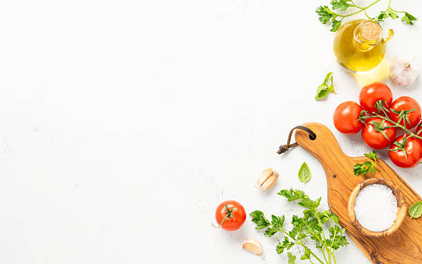 istock Spices, herbs and vegetables with olive oil on white kitchen table. 2223665547