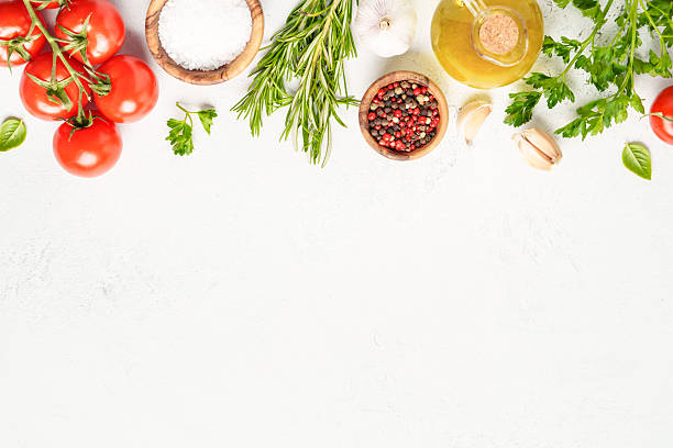 istock Spices, herbs and vegetables with olive oil on white kitchen table. 2223665550