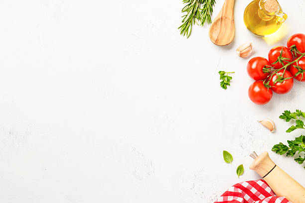 istock Spices, herbs and vegetables with olive oil on white kitchen table. 2223665557
