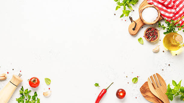 istock Spices, herbs and vegetables with olive oil on white kitchen table. 2223665581