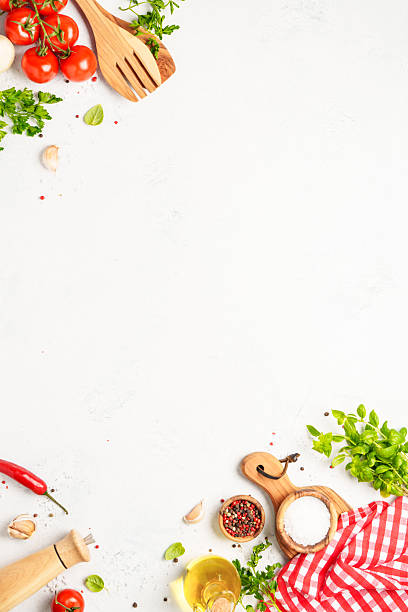 istock Spices, herbs and vegetables with olive oil on white kitchen table. 2223665588