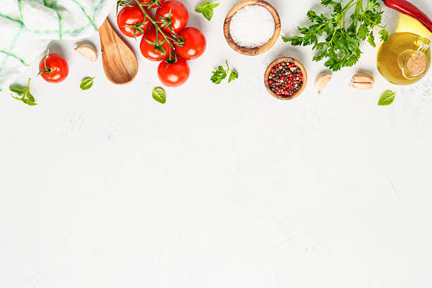 istock Spices, herbs and vegetables with olive oil on white kitchen table. 2223665614