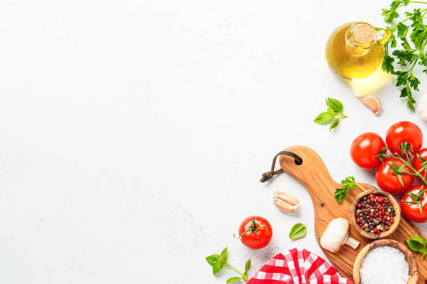 istock Spices, herbs and vegetables with olive oil on white kitchen table. 2223665638