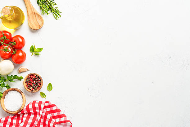 istock Spices, herbs and vegetables with olive oil on white kitchen table. 2223665646