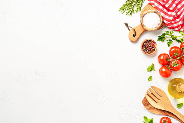istock Spices, herbs and vegetables with olive oil on white kitchen table. 2223665653