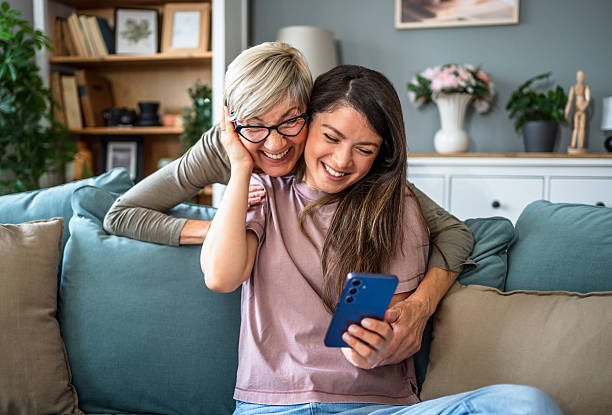 istock Mother and daughter sharing a happy moment while using a smartphone at home 2223665654