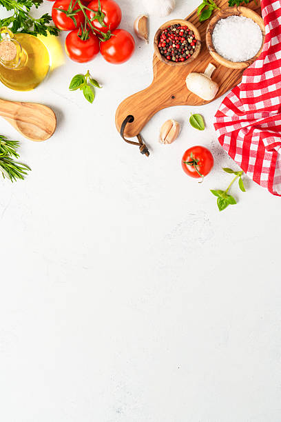 istock Spices, herbs and vegetables with olive oil on white kitchen table. 2223665655
