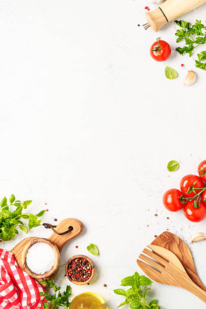 istock Spices, herbs and vegetables with olive oil on white kitchen table. 2223665667