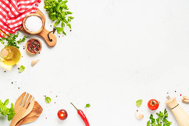 istock Spices, herbs and vegetables with olive oil on white kitchen table. 2223665669