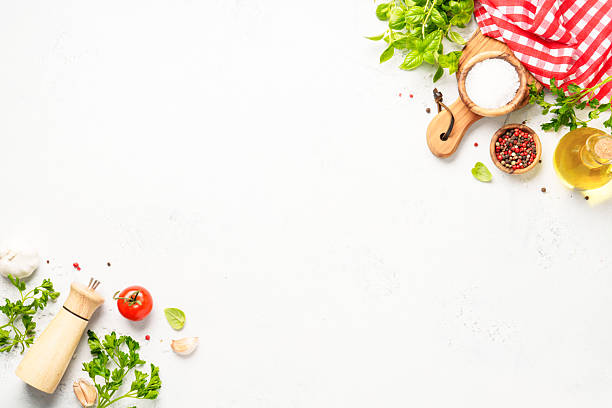 istock Spices, herbs and vegetables with olive oil on white kitchen table. 2223665670