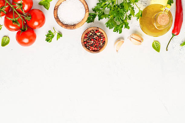 istock Spices, herbs and vegetables with olive oil on a  white kitchen table. 2223665699
