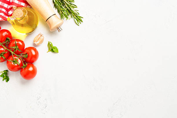 istock Spices, herbs and vegetables with olive oil on a white kitchen table. Flat lay image with copy space. 2223665757
