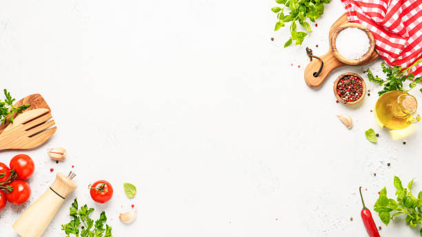 istock Spices, herbs and vegetables with olive oil on a white kitchen table. Flat lay image with copy space. 2223665765