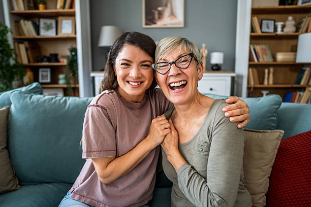 istock Mother and daughter sharing a laugh on the sofa at home 2223665913
