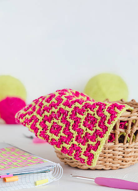 istock The process of creating a tote bag with a bright ethnic geometric pattern. Pink yellow crochted texture. Freelance and creative working concept. 2223666736