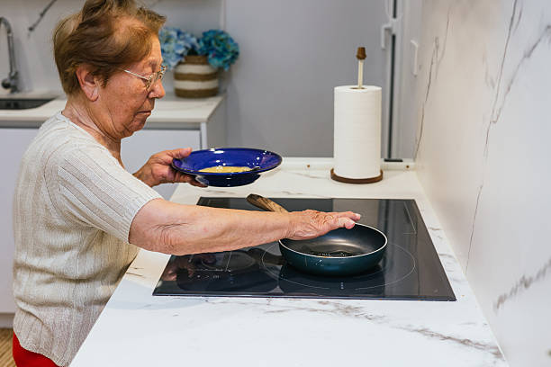 istock Elderly Woman Cooking in Modern Kitchen Setting 2223666746