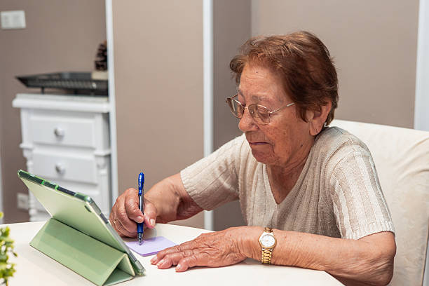 istock Elderly Woman Engaging in Writing Activity at Home 2223666771