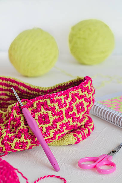 istock The process of creating a tote bag with a bright ethnic geometric pattern. Pink yellow crochted texture. Handmade concept. 2223666795